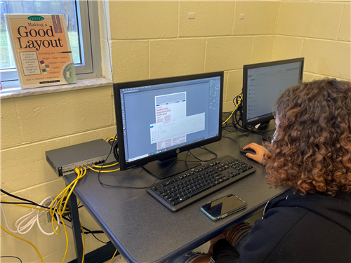 A student using InDesign to prepare the next issue of the student newspaper